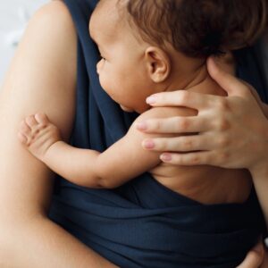 Mother holding her baby in sling